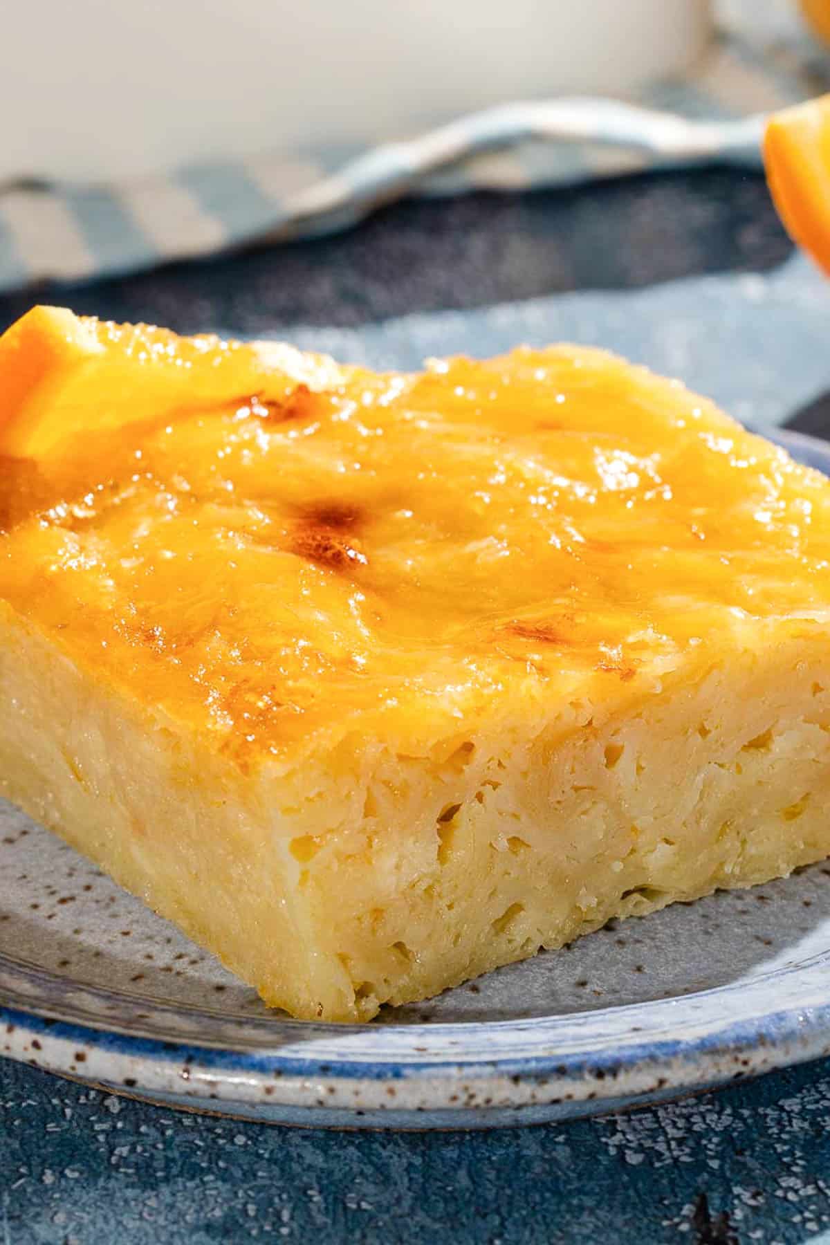 A close up of a piece of portokalopita greek orange cake on a plate.