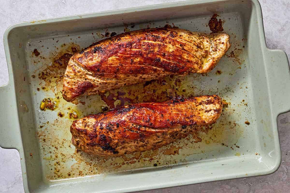 2 baked pork tenderloins in a baking dish.