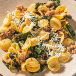 A close up of orecchiette with sausage and broccoli rabe on a plate.