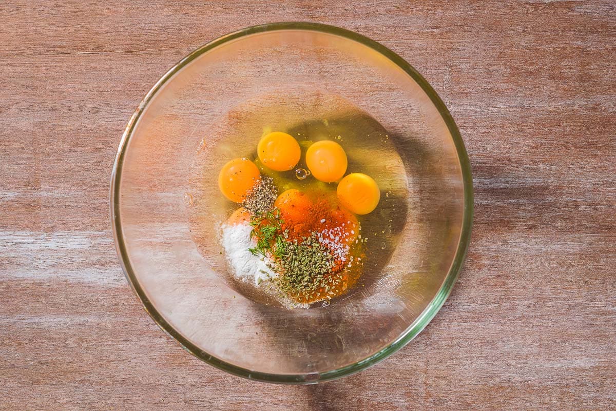 The ingredients for the frittata in a bowl with a whisk just before being mixed together.