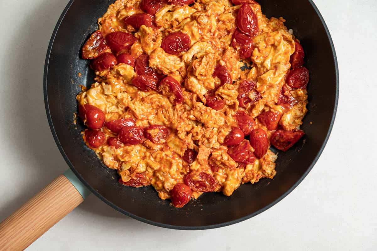 An overhead photo of strapastada greek tomato scrambled eggs in a skillet.