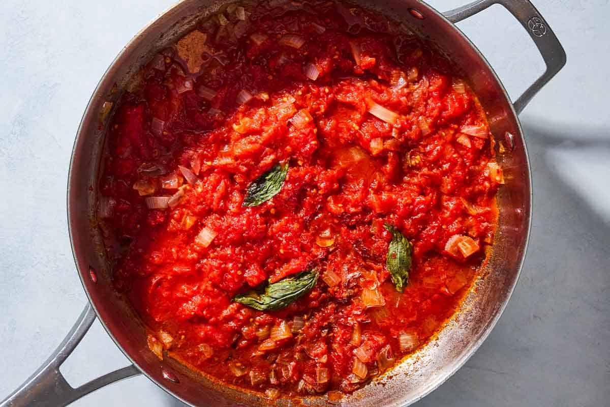 An overhead photo of the sauce for the sfincione sicilian pizza in a saucepan.