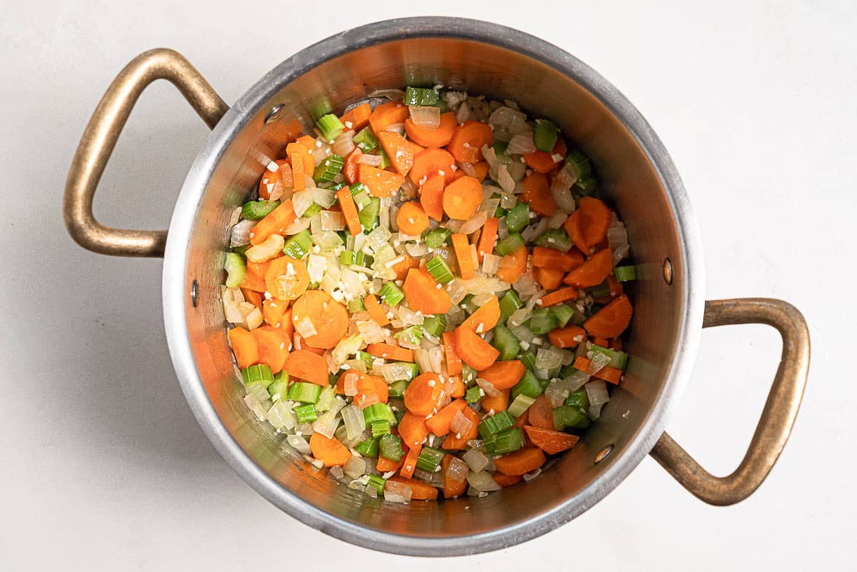 The sauteed chopped vegetables for the revithosoupa Greek chickpea soup in a large pot.