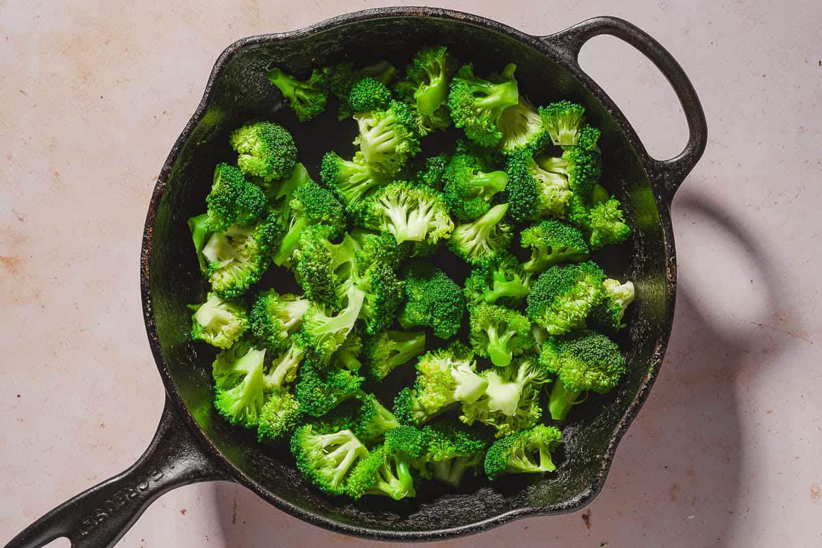 An overhead photo of broccoli florets in a skillet.