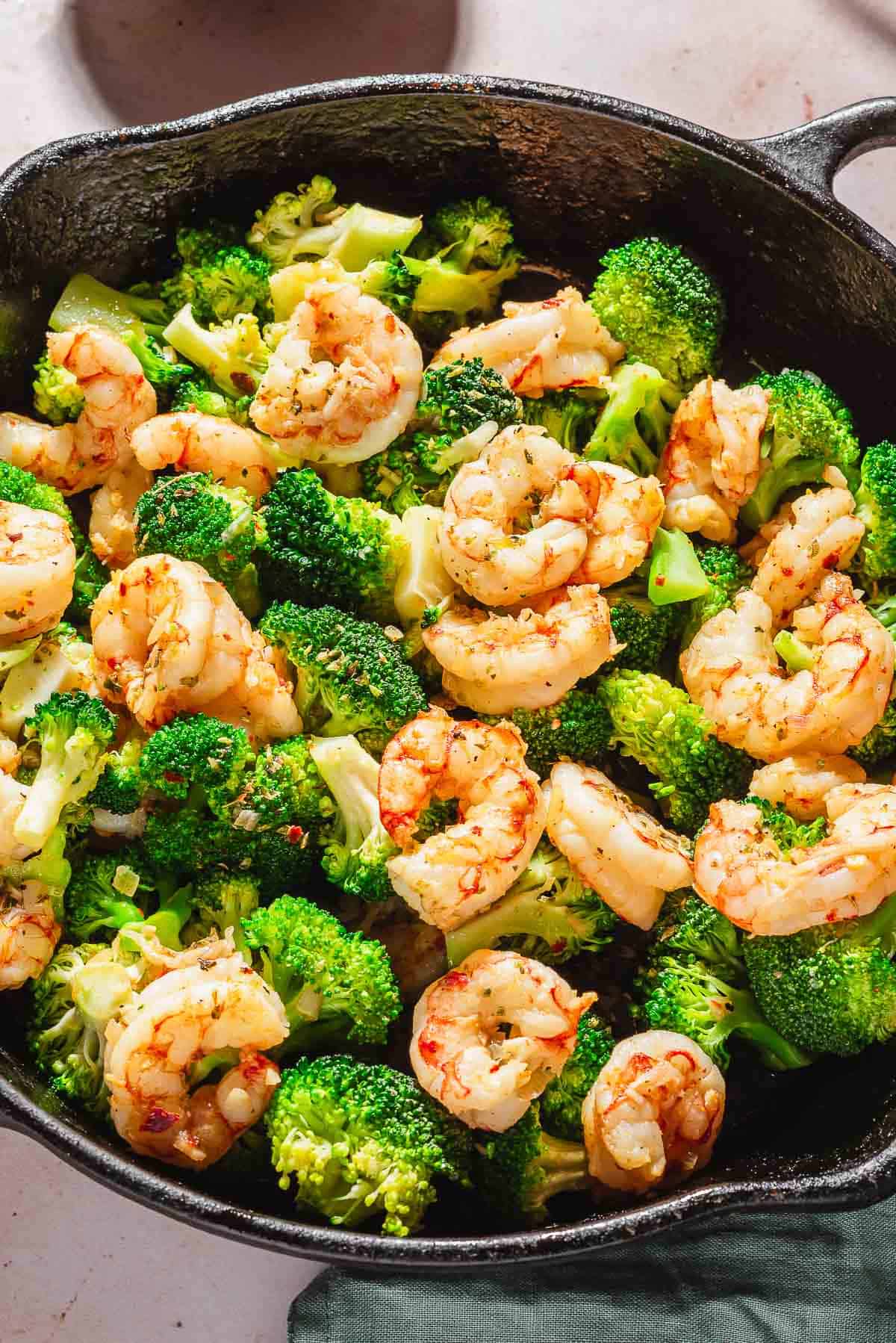 A close up of the the cooked shrimp and broccoli recipe in a skillet.