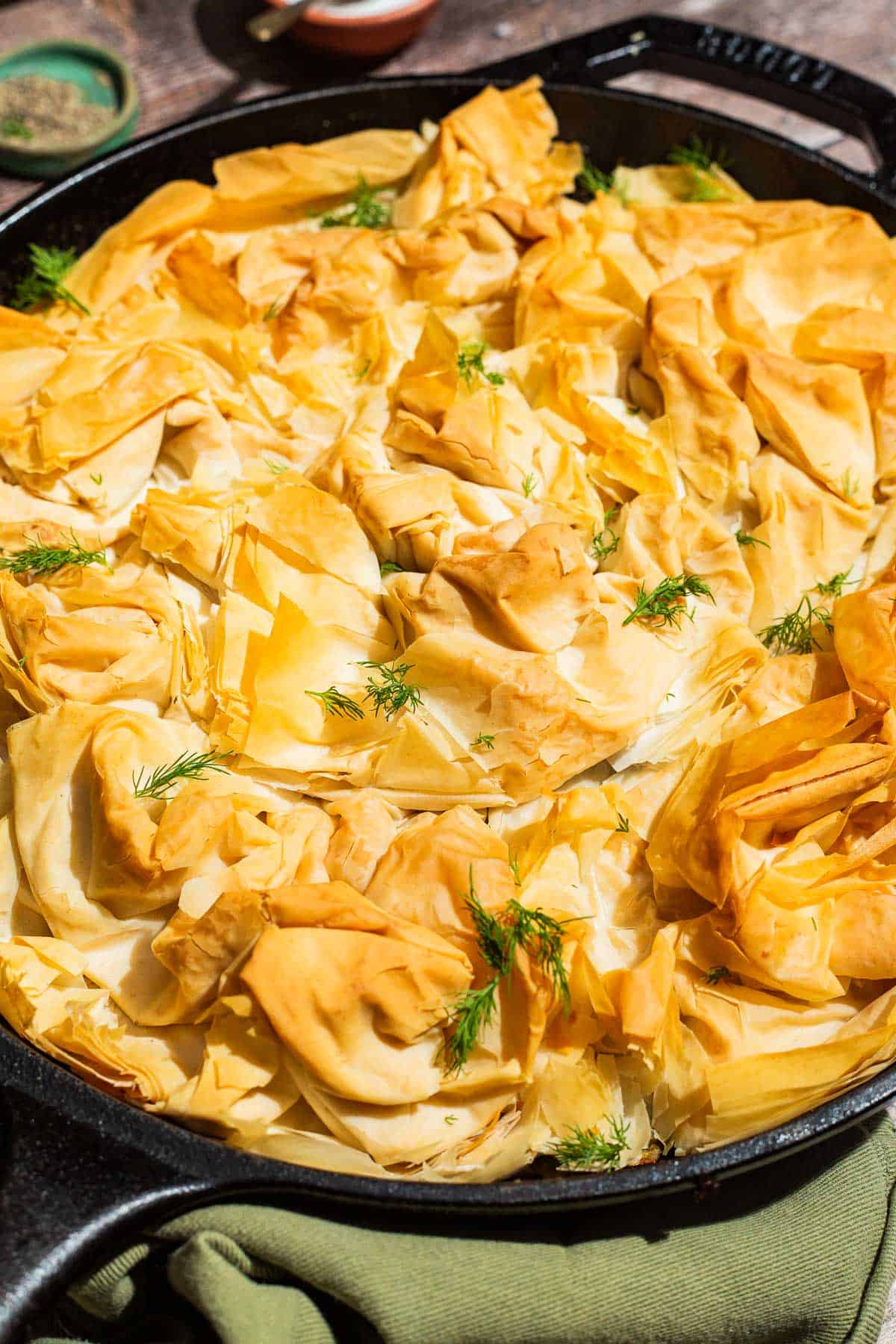 A close up of vegan skillet spanakopita in a skillet.