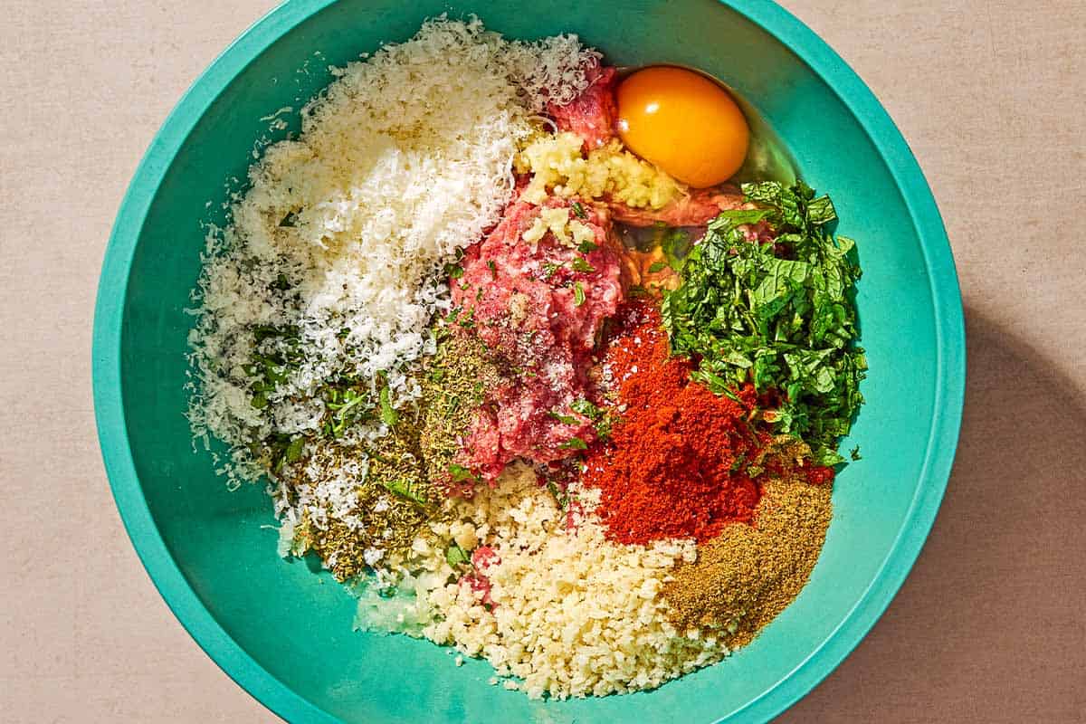 The ingredients for the greek meatloaf recipe in a bowl just before being mixed together.