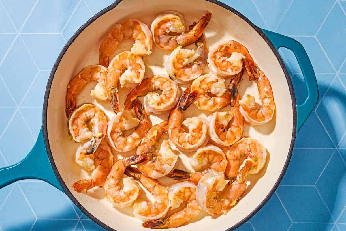 An overhead photo of shrimp in a skillet before being sauteed.