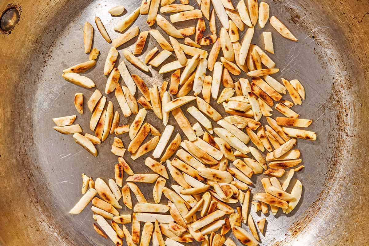 Toasted slivered almonds in a skillet.