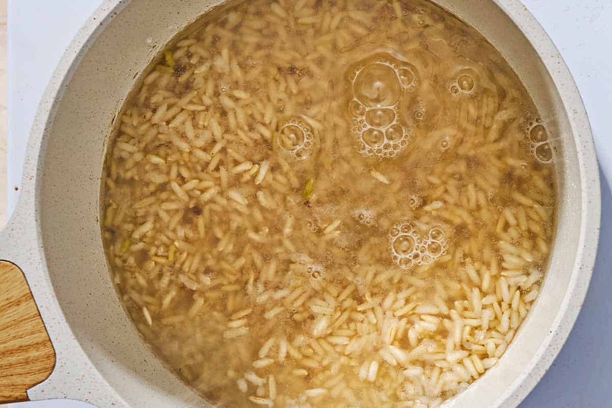 An overhead photo of rice cooking in a saucepan.