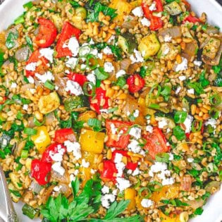 The roasted vegetables barley recipe In a bowl with a fork.