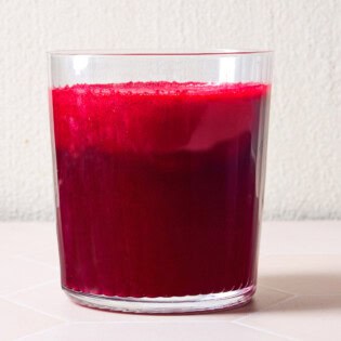 Beet juice in a glass cup.