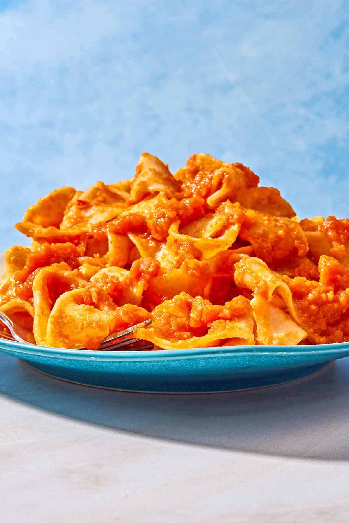 Pasta tossed with lentil bolognese on a plate.