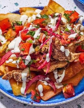 A serving of chicken nachos on a plate.