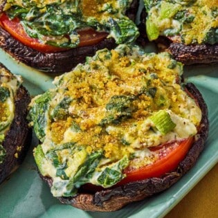 Stuffed portobello mushrooms on a platter.