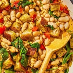 The ground turkey dinner in a skillet with a wooden spoon.