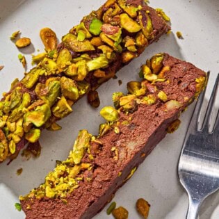 2 slices of healthy chocolate mousse on a plate with a fork.