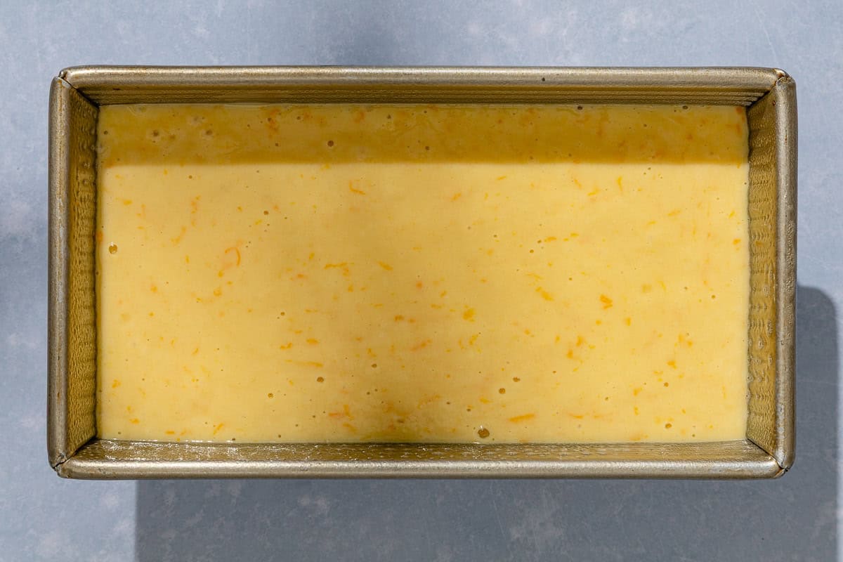 The batter for the orange cake in a loaf pan.